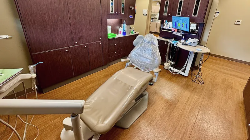 Dental chair with computer cart and monitors in a modern operatory