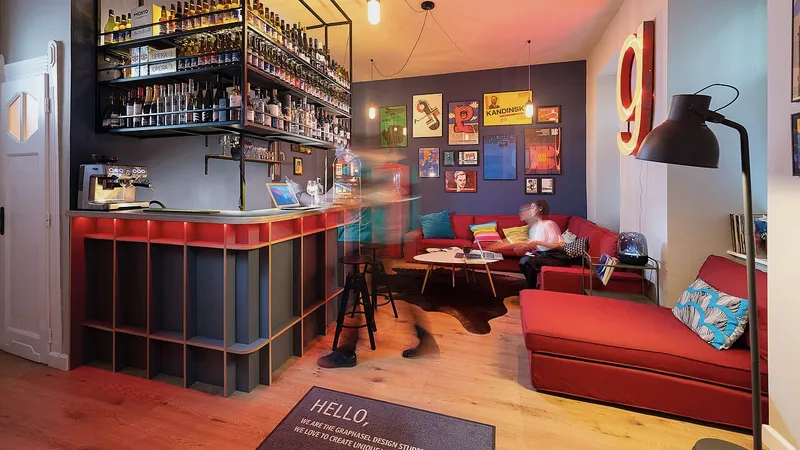 Design studio lounge with red sofas and framed posters