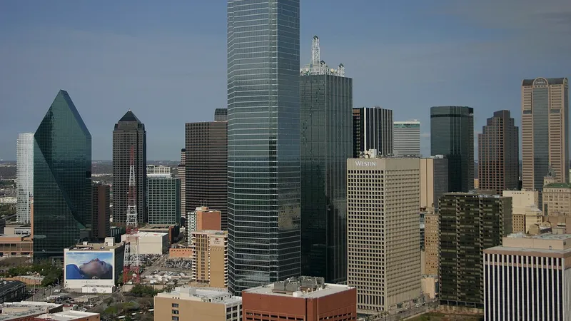 Downtown Dallas office towers under a clear blue sky