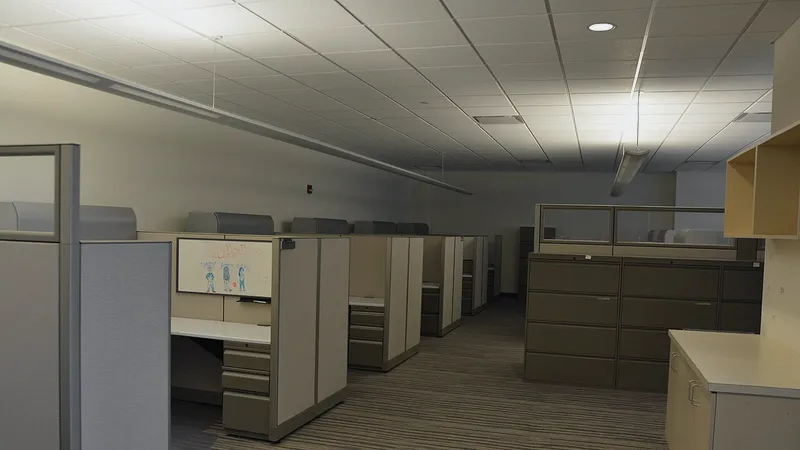 Empty office with unoccupied cubicles and no one working
