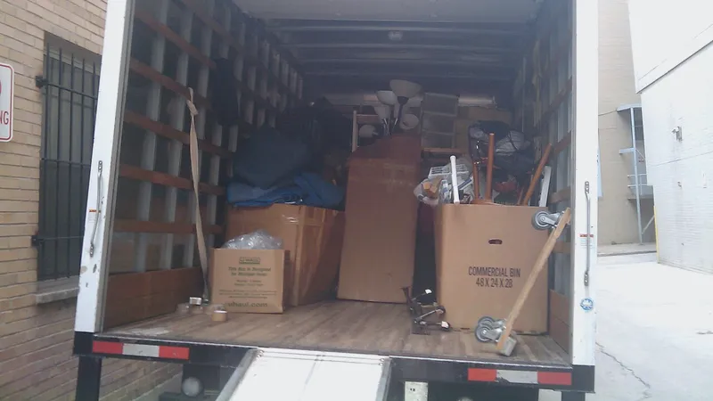 Moving truck with open doors loaded with boxes